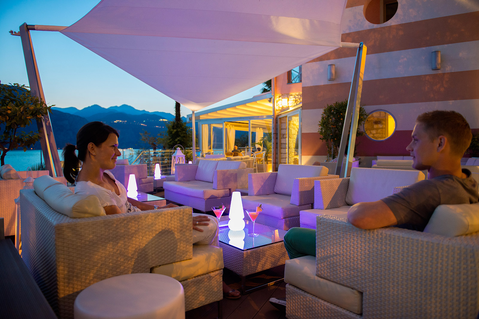 The lounge terrace at dusk over the lake